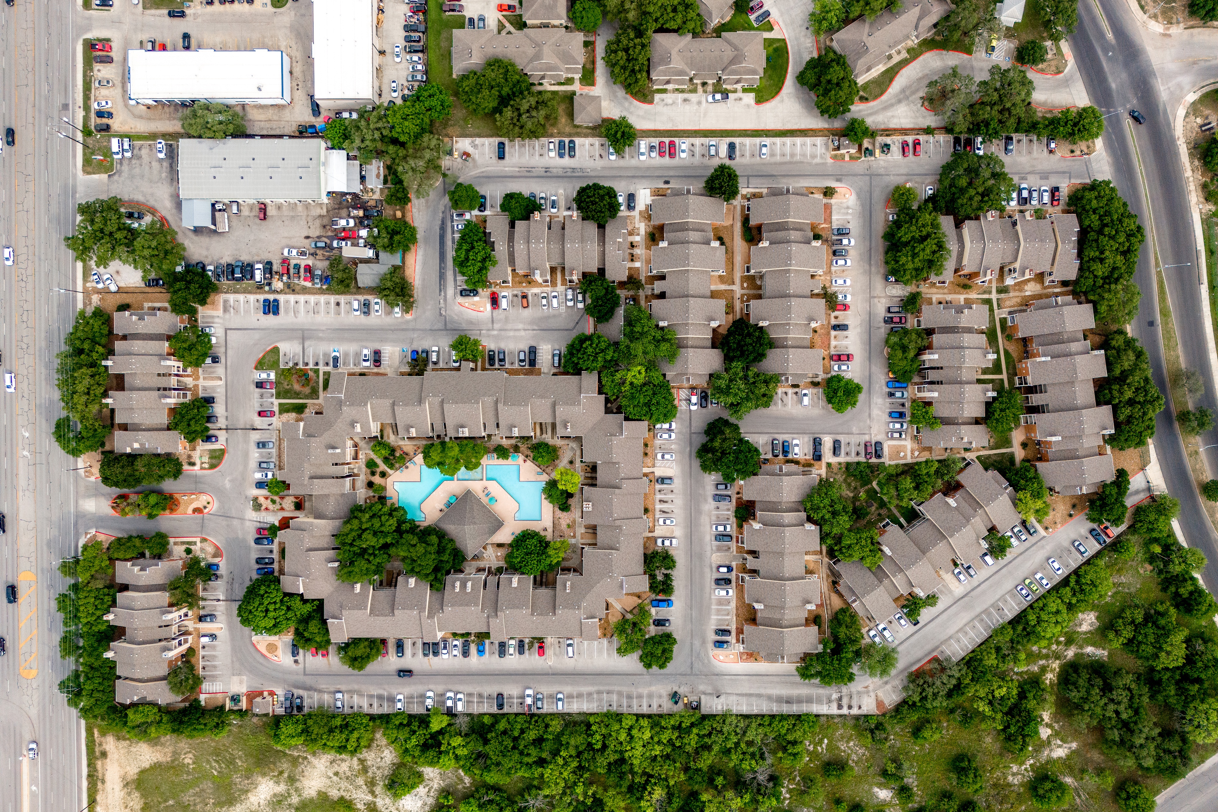 An aerial view of a residential complex with a swimming pool.